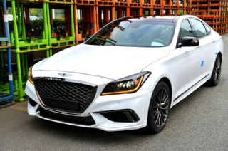 Illustration for article titled Genesis G80 Sport, The Blue Seated Carbon Fiber Trimmed Gold Stiched Steering Wheel Twin-Turbo Sedan All Three Of Us Have Been Waiting For...